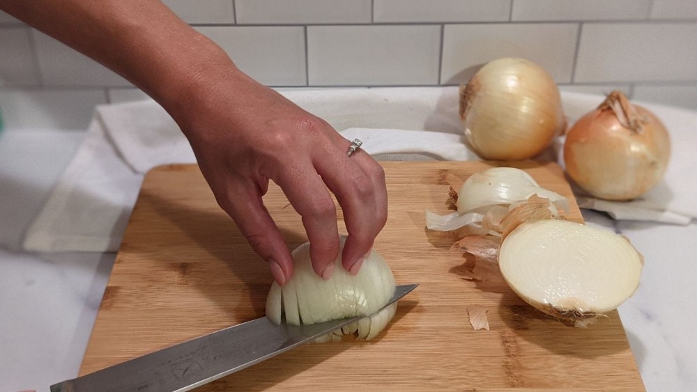 Slicing an onion horizontally a few times before dicing.