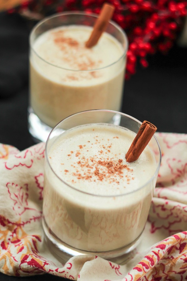 Vegan eggnog! This eggless eggnog has all of the flavor and texture of regular eggnog. This is a festive and healthy holiday drink! Recipe here: fitnessista.com #eggnogrecipe #veganeggnog #egglesseggnog