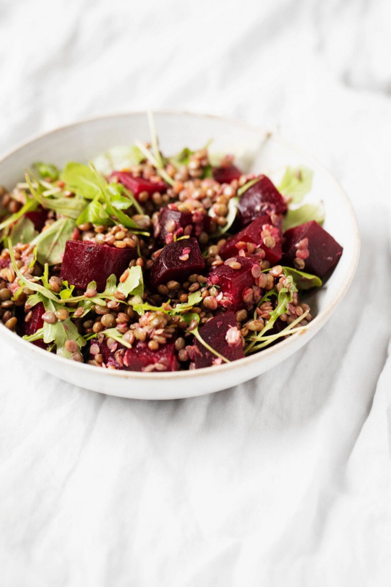 A small bowl contains a fresh, colorful, plant-based salad.