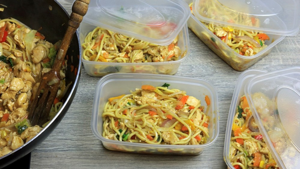 Stir-fry in a wok and four storage containers. 