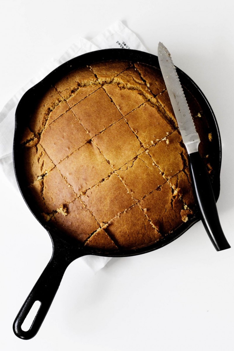 Vegan pumpkin skillet cornbread, cut into squares and ready to be eaten.