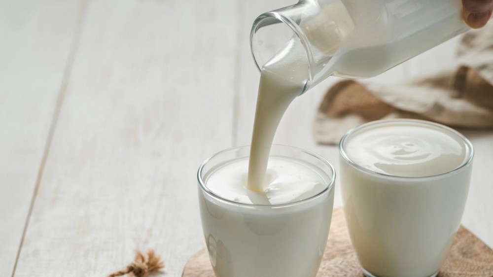 Someone pours homemade Kefir