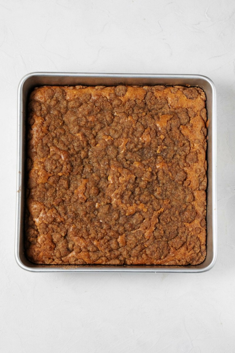 The top of a vegan coffee cake, which is covered with buttery streusel.